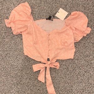 Pink with cream flower pattern crop top.